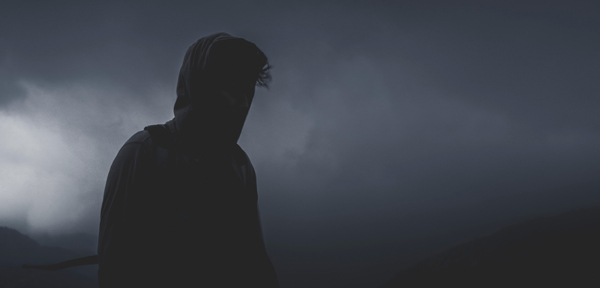 man silhouette stormy sky behind him