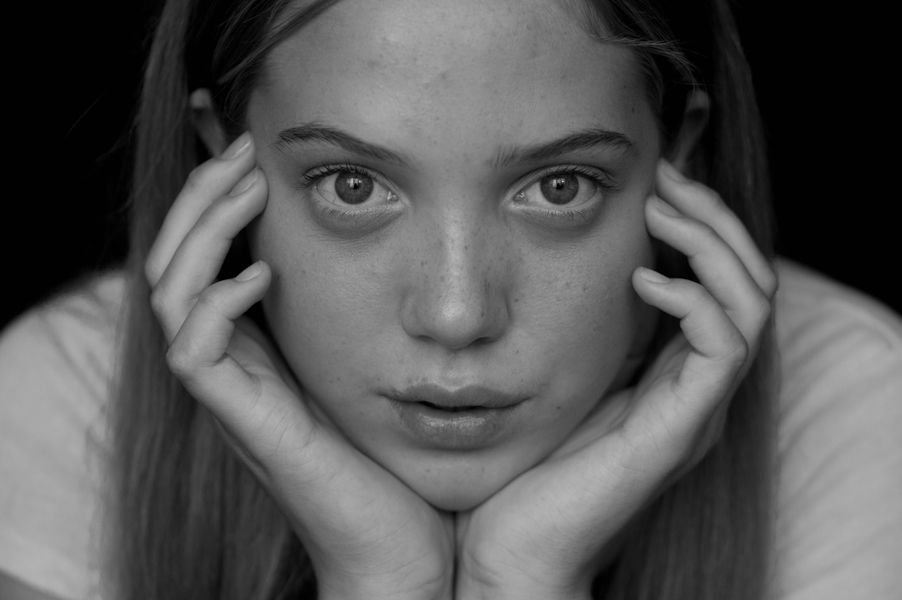 teen girl resting her chin in her hands