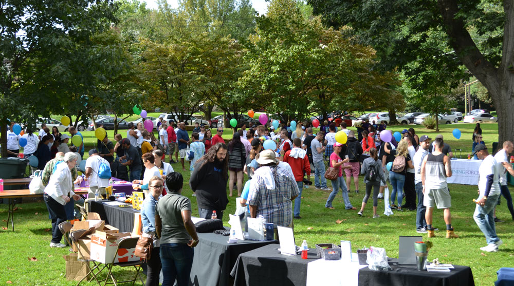 A large crowd gathers for Recovery Day Lancaster 2018 in a green park.