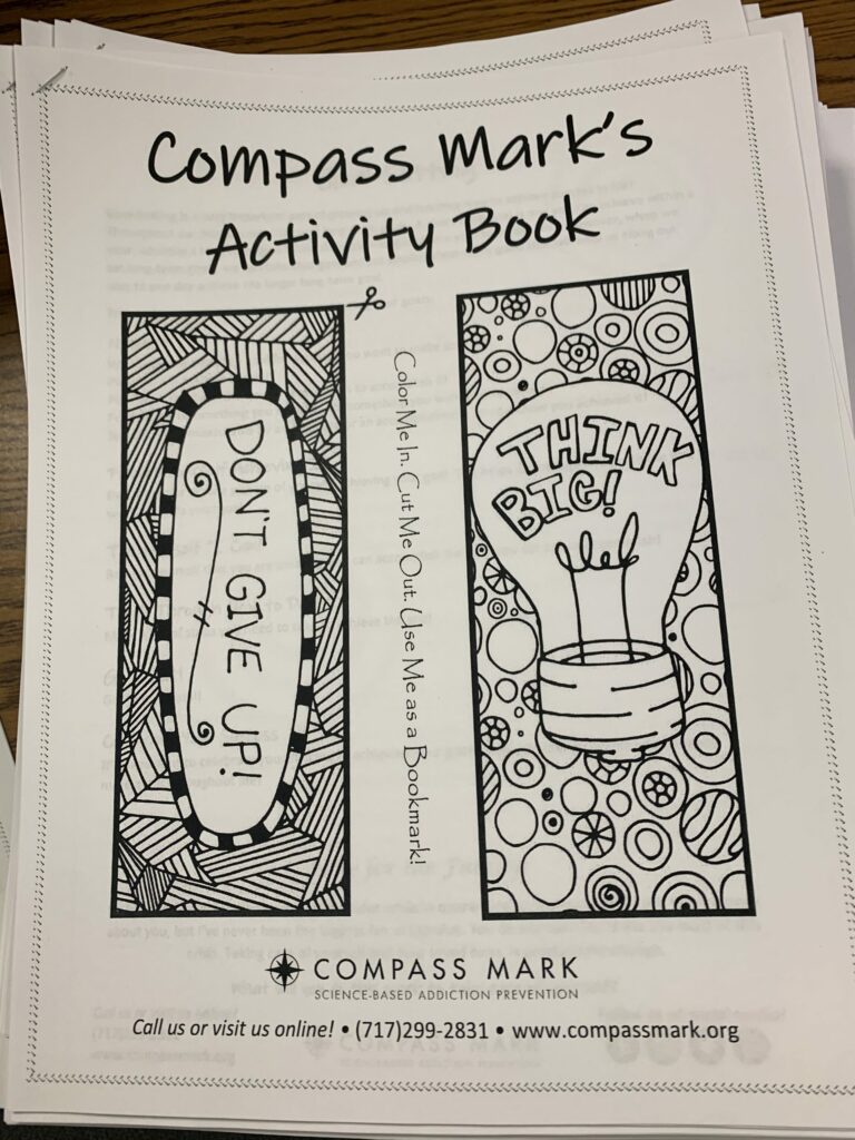 A black and white drawing with bookmarks to color and the headline "Compass Mark's Activity Book"