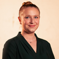 Headshot of a woman in professional clothing- smiling slightly and looking into the camera.