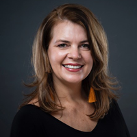 Headshot of a woman in professional attire, smiling.