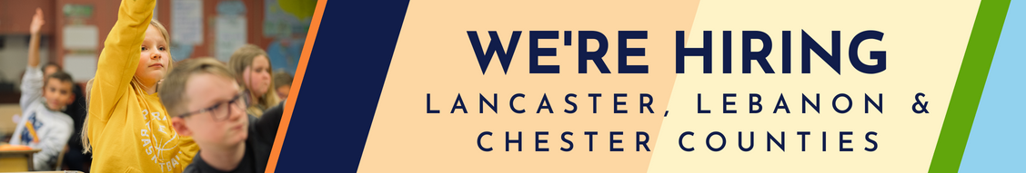 Banner with a close-up of elementary kids in a classroom with the words, We're Hiring: Lancaster, Lebanon and Chester Counties.
