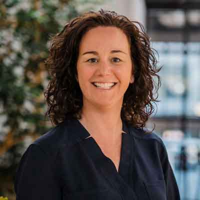 Headshot of woman in business casual clothing, smiling