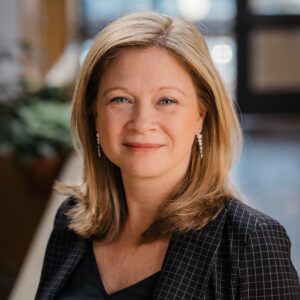 Headshot of a professional woman in an atrium with lots of light