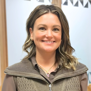 Headshot of a woman in an indoor atrium, smiling.